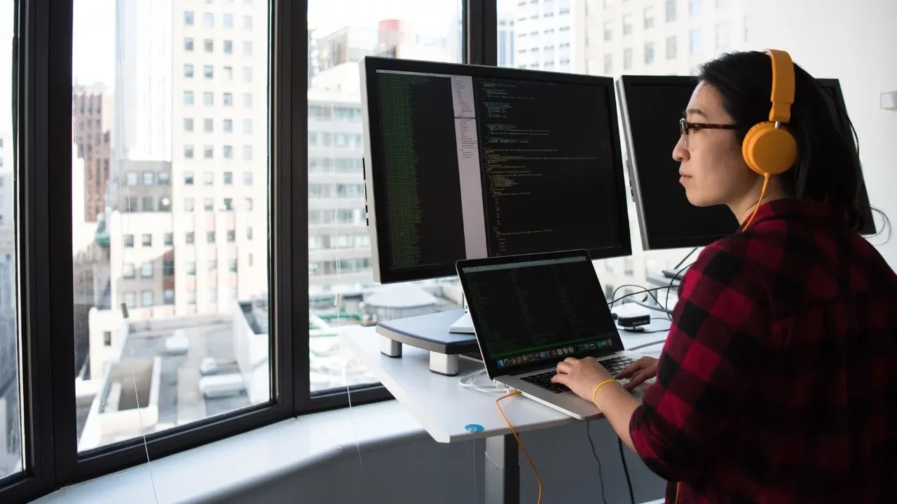 Close up on a plate of mashed potatoes, topped with baked pork chops with cream of mushroom soup, and a side of green beans.