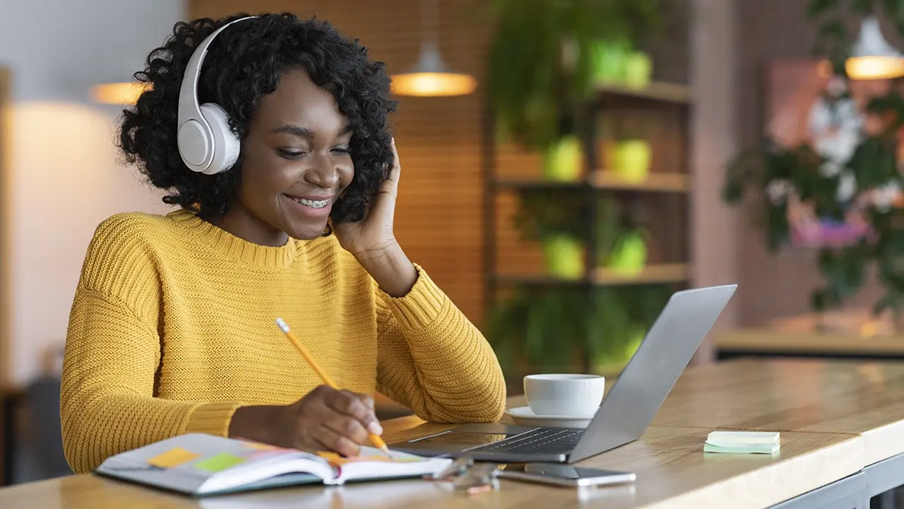 Close up on a plate of mashed potatoes, topped with baked pork chops with cream of mushroom soup, and a side of green beans.