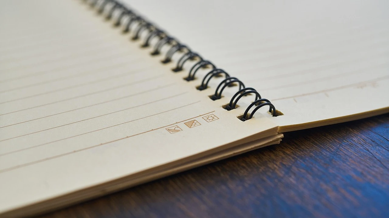 Close up on a plate of mashed potatoes, topped with baked pork chops with cream of mushroom soup, and a side of green beans.