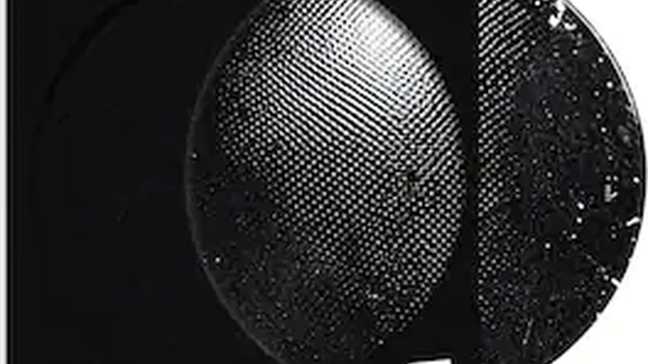 Close up on a plate of mashed potatoes, topped with baked pork chops with cream of mushroom soup, and a side of green beans.